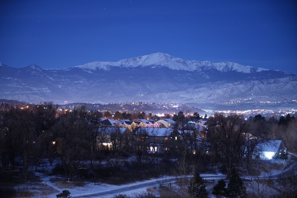 Brown and white houses near snow covered mountain during daytime — Aurora, CO