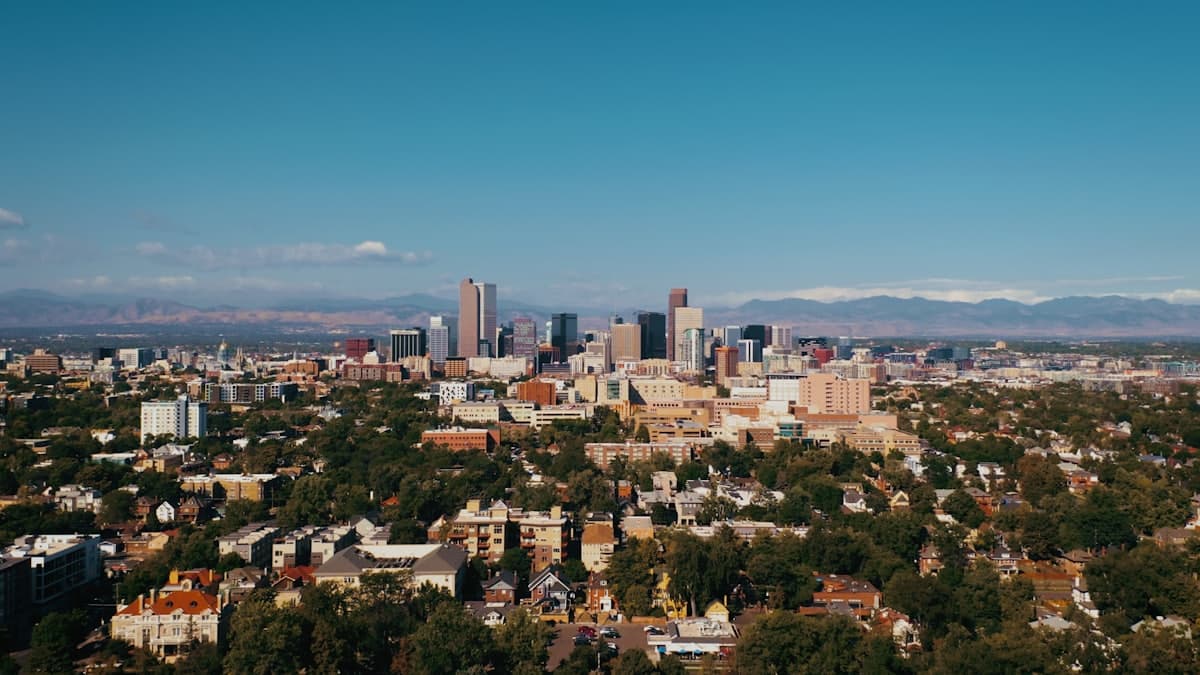 A view of a city with mountains in the background — Denver, CO