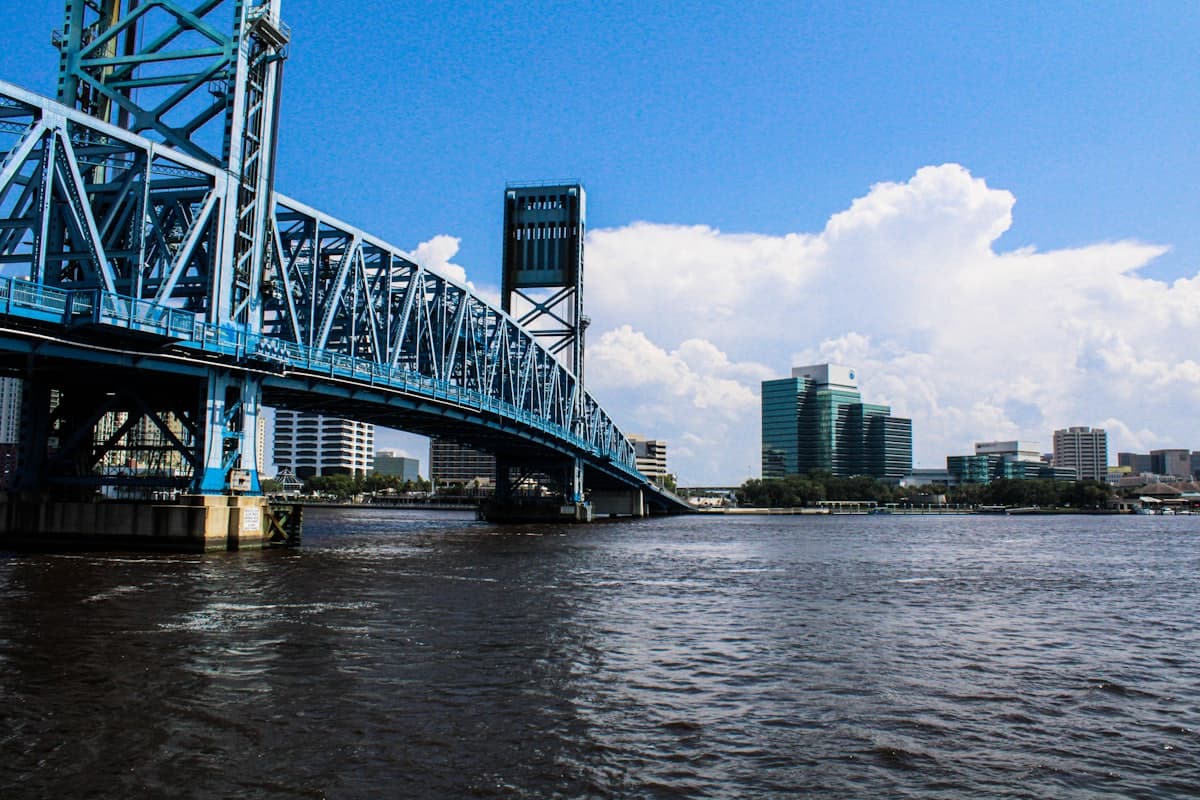 A bridge over a body of water with a city in the background — Jacksonville, FL