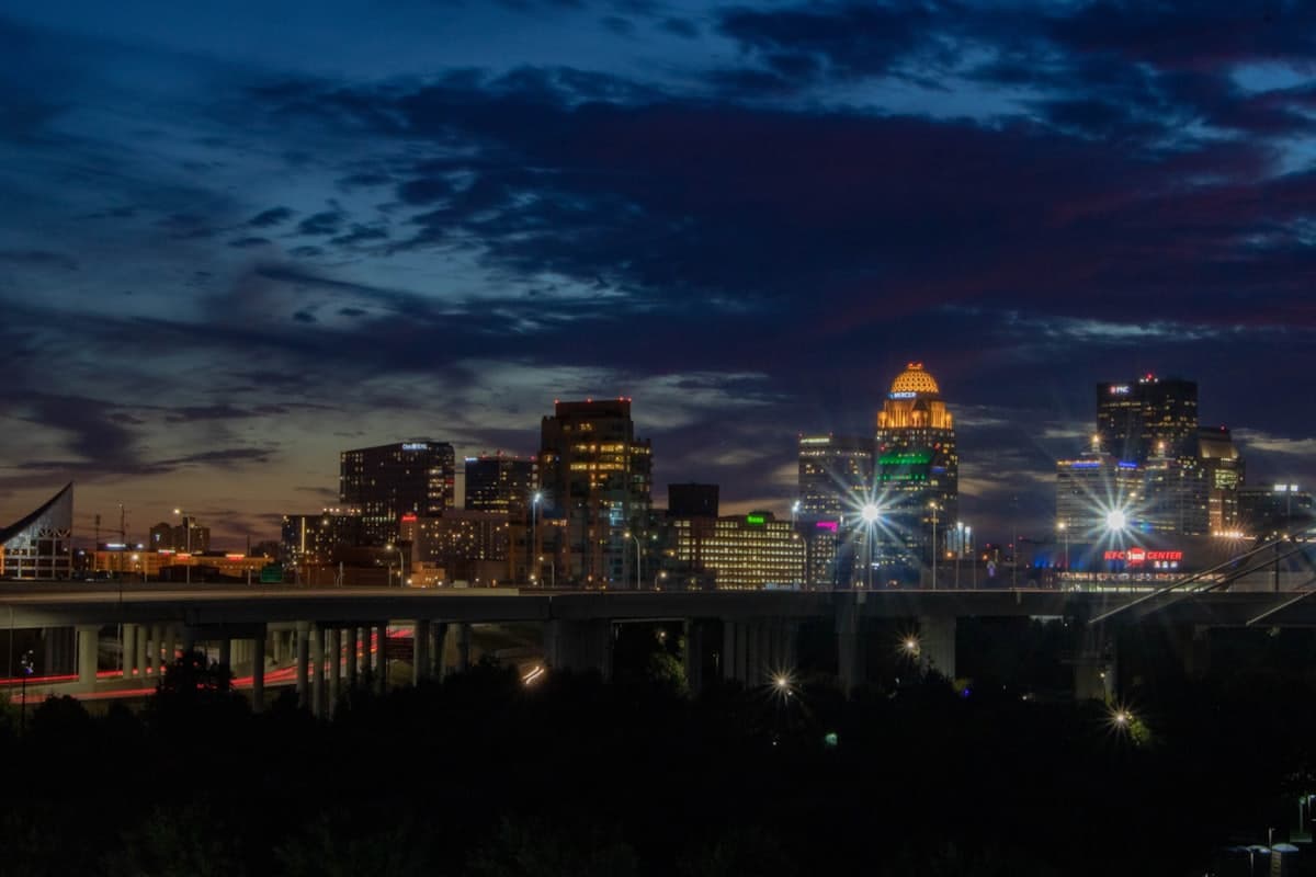 City skyline at dusk with illuminated buildings — Louisville, KY