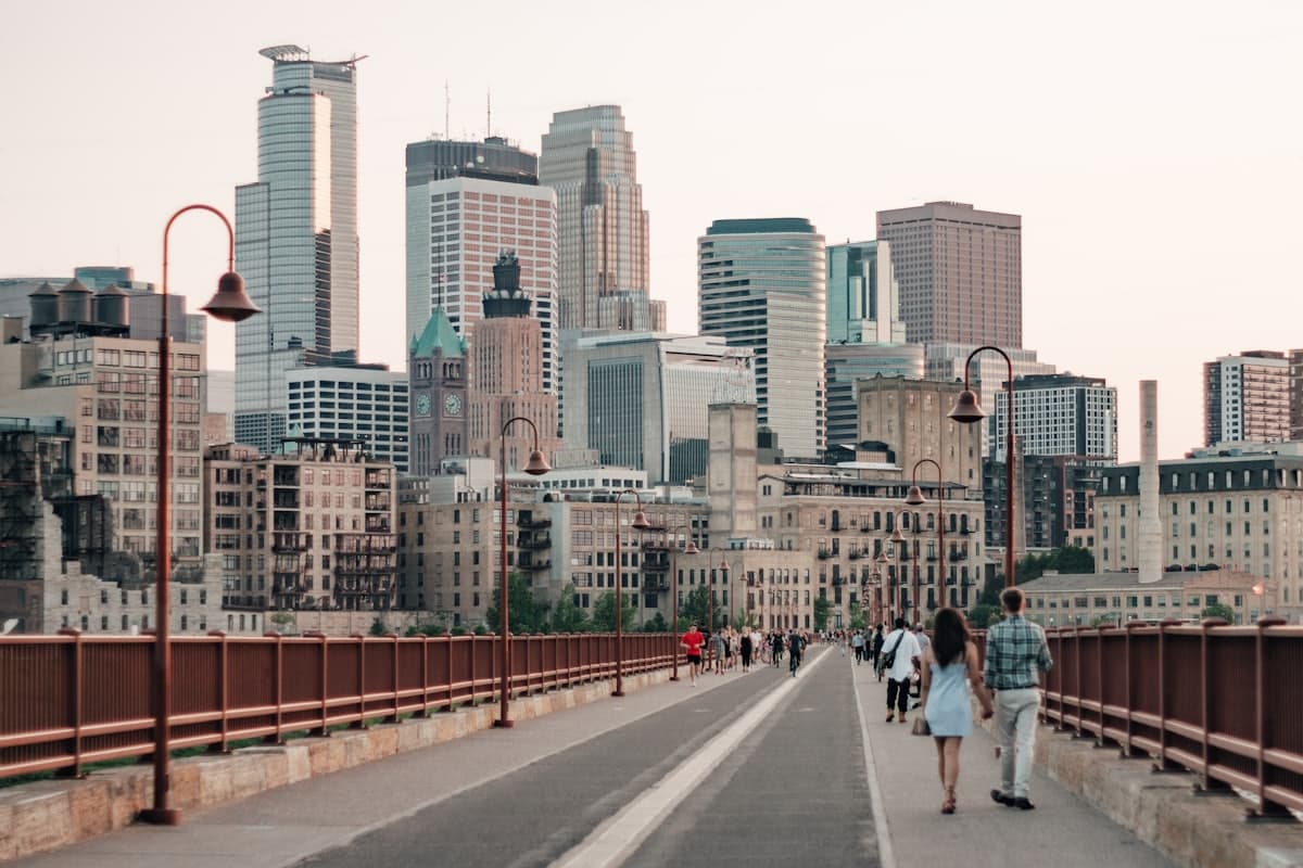 People walking on sidewalk near city buildings during daytime — Minneapolis, MN