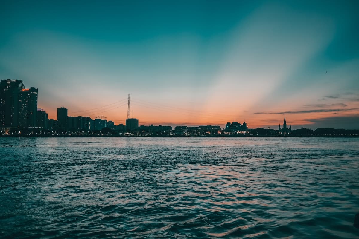 A body of water with a city in the background — New Orleans, LA